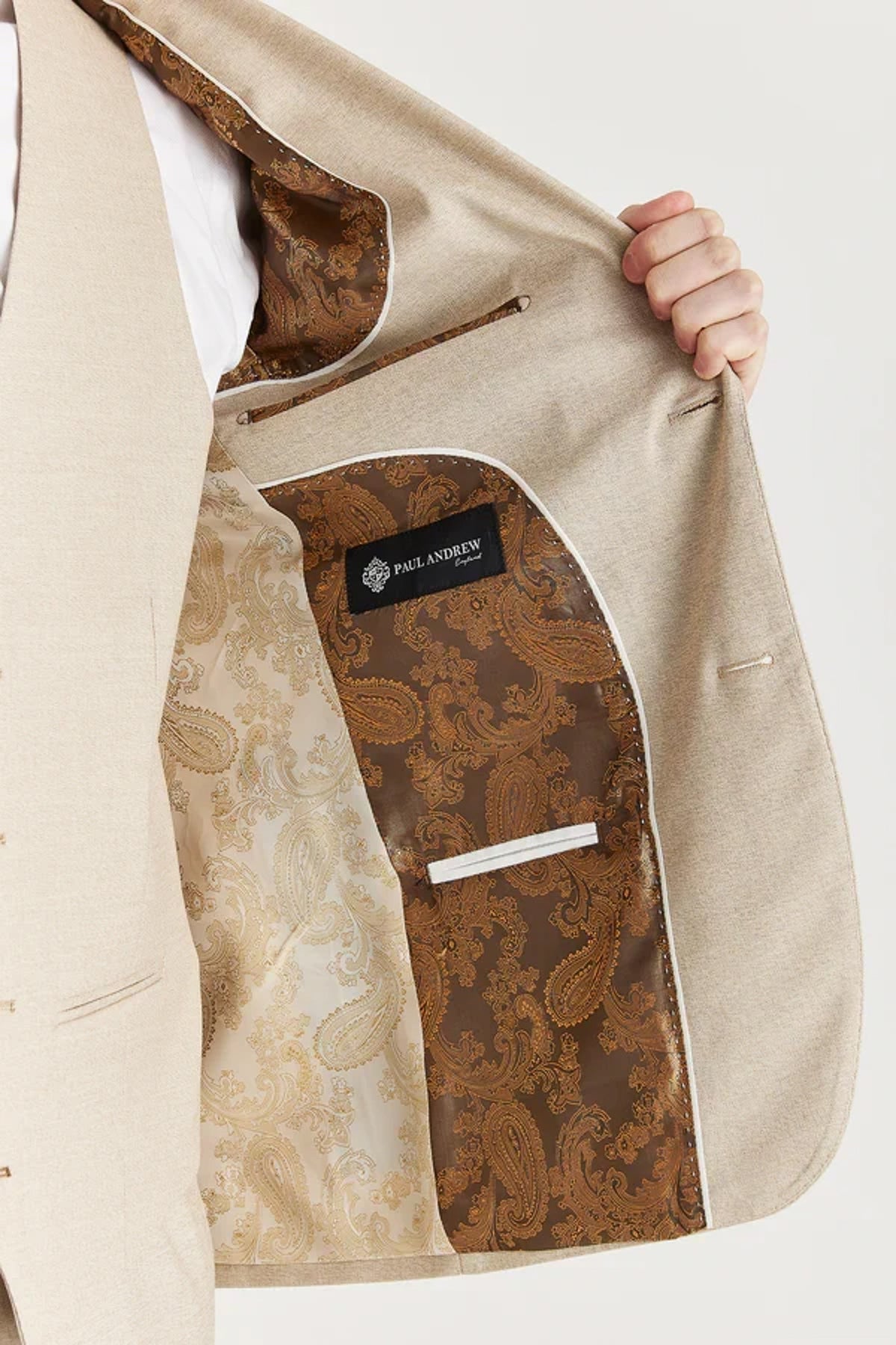 Beige blazer with brown paisley pattern on a white background